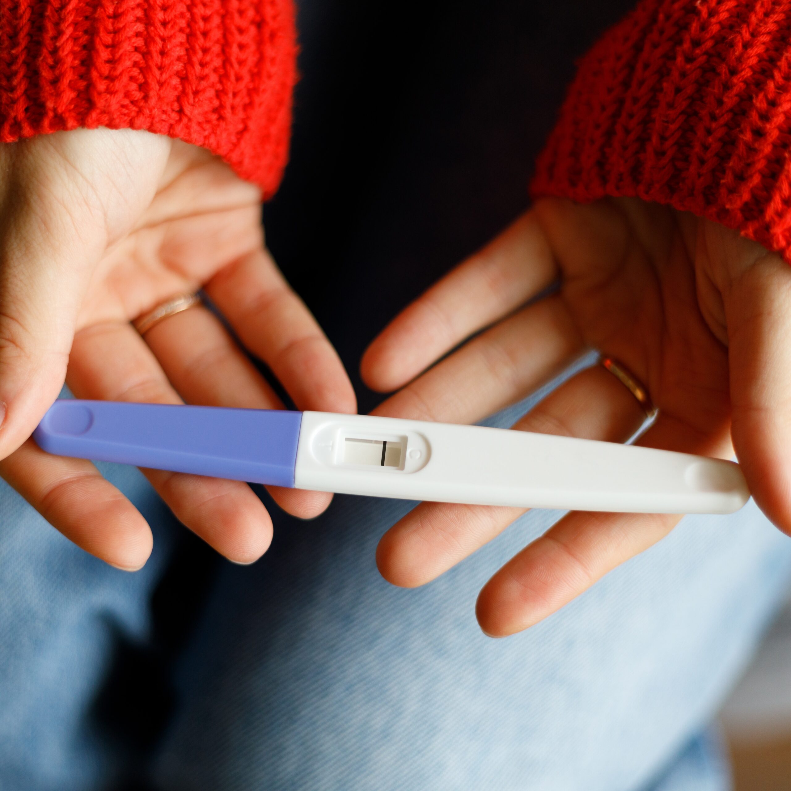 Negative Pregnancy Test With One Strip In Female Hands, Close-up.